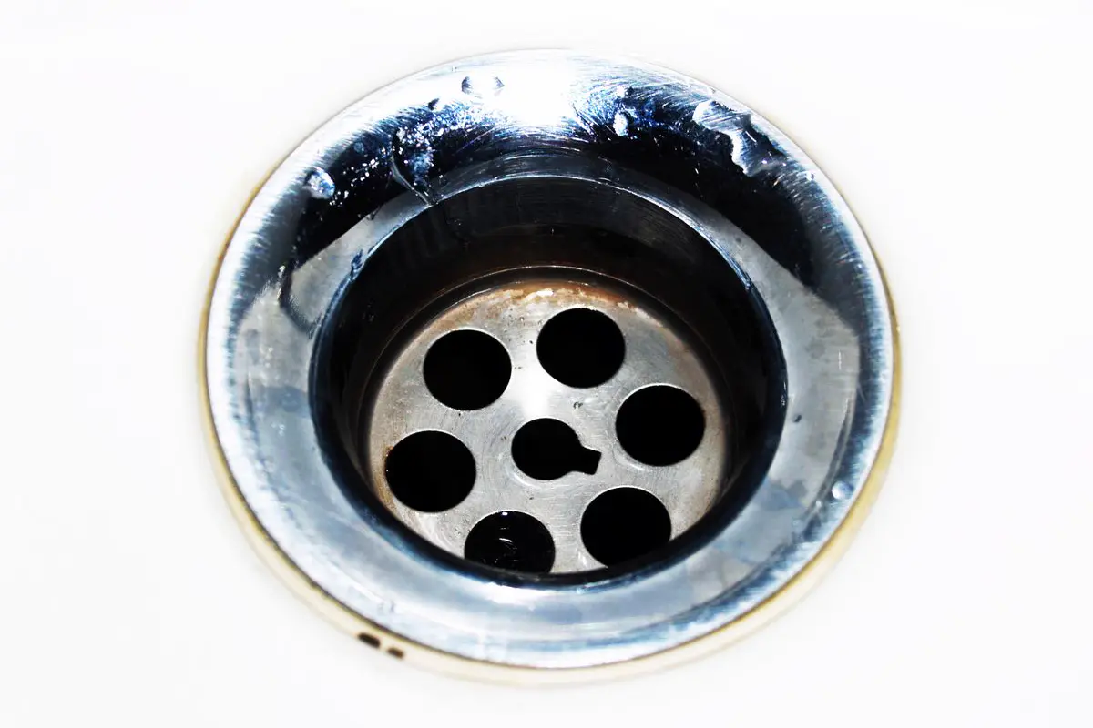 Free Detailed image of a chrome sink drain showcasing water droplets and a metallic finish. Stock Photo